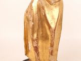 statue of a man in a cloak on a pedestal with a book