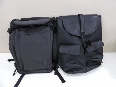 two bags that are sitting on a white table