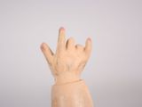 a clay hand that is holding up a peace sign