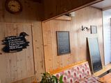 a bench and a table in a room with wood paneled walls