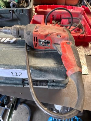 an image of a drill on a workbench in a garage