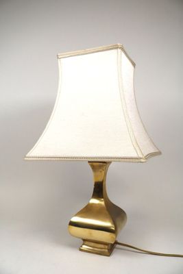 lampe de table en laiton avec un abat-jour blanc sur fond blanc