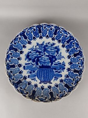 a blue and white plate with flowers on it sitting on a table