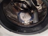 a close up of a washing machine with the door open