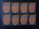six decks of magic the gathering cards are arranged on a table