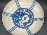 a blue and white plate with a flower design on it