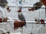 an image of a table cloth with a picture of birds on it