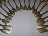 a lot of spoons arranged in a circle on a table