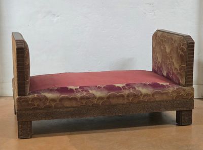 a small wooden bench with a pink cushion on it