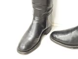 a pair of black boots that are next to each other