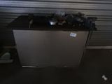 an image of a small refrigerator in a garage