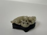 une petite figurine représentant un chien et un chat posée sur une table