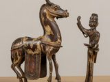 a statue of a horse and a man standing next to each other