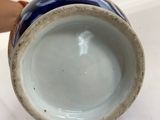 a small blue and white vase on a table