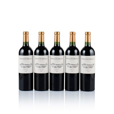 three bottles of wine are lined up on a white surface