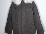 an image of a coat with a fur collar on a mannequin stand