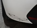 a close up of a car ' s rear end on a metal floor