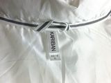 the label on a white dress is attached to the back of the dress