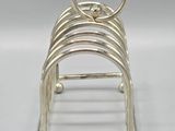 silver plated napkin holder with four rings on each side