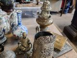 de nombreux vases et autres objets posés sur la table