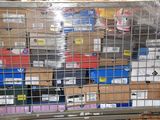a metal cage with a bunch of boxes behind it