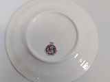 a white plate with a pink and black design on it