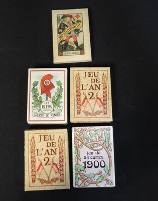 four cards with different designs on them on a black surface