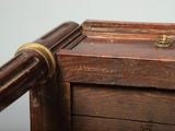 a close up of a wooden table with a metal handle