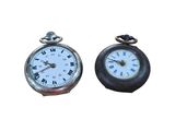 two clocks sitting next to each other on a white surface