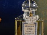 a bottle of perfume sitting on a table next to a book