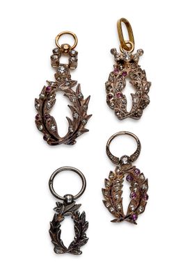 three pairs of earrings and a ring on a white background