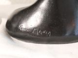 a black vase that is sitting on a white cloth