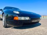 une photo d'une voiture de sport noire garée sur un parking