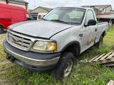 a truck that is sitting in the grass in the yard