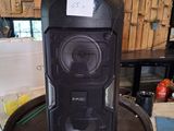 a speaker that is sitting on top of a barrel