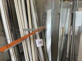 many different types of metal pipes in a storage area