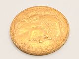 a gold coin with a picture of a horse on it