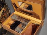 a wooden box with a mirror, brush, and other items in it