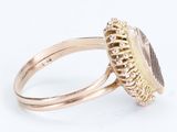 a close up of a gold ring with a stone in the middle