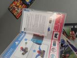 someone is holding a nintendo wii game in a clear case