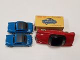 three toy cars are sitting next to each other on a table
