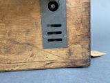 an old wooden box with a button on it