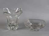 two glass vases sitting next to each other on a table