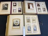 several old photos of people are arranged in a row on a table