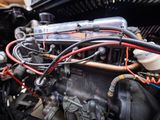 a close up of a car engine with wires attached to it