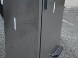 a small refrigerator on a dolly in a parking lot