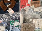 several pairs of men ' s clothing are packed in plastic bags
