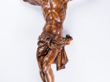 an antique wooden crucifix of jesus hanging on a wall