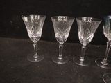 four empty wine glasses sitting on a black surface