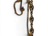 an image of a pair of brass ear clips on a white background